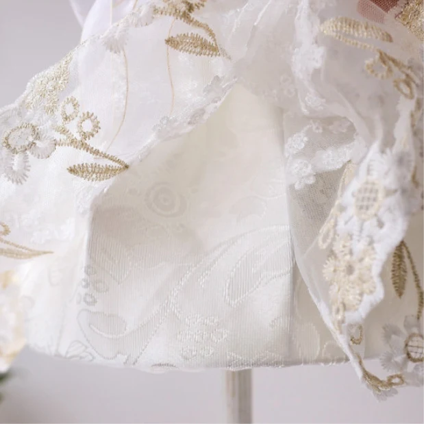 Close detail of scalloped lace trim and embroidered floral shade