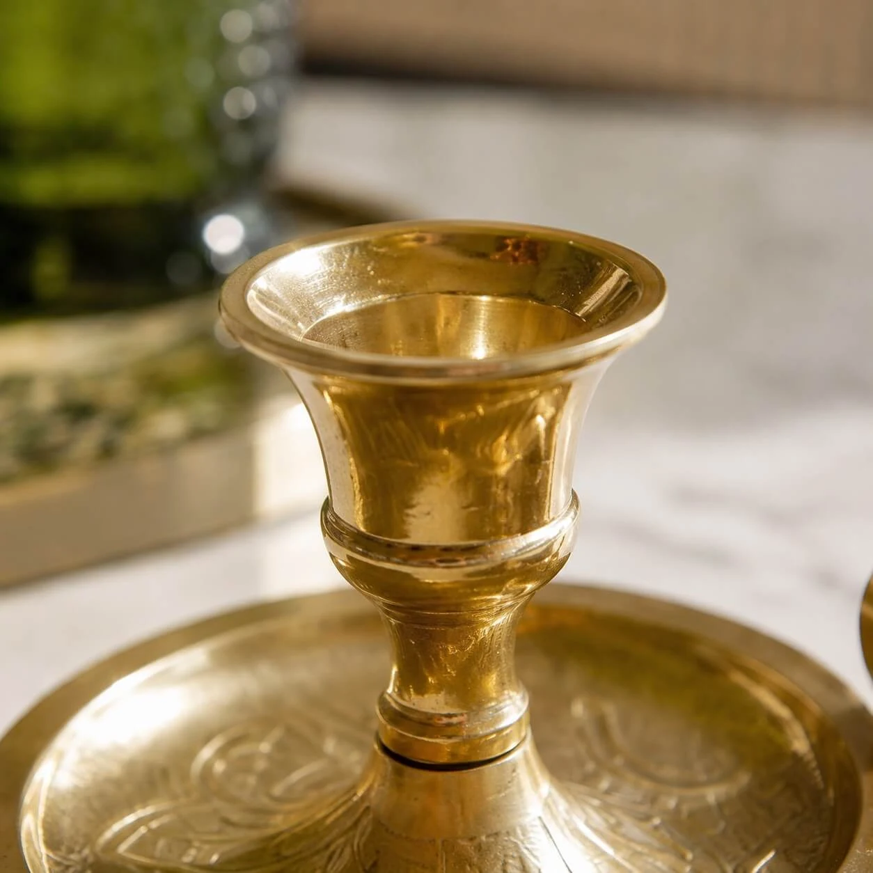 Raised brass candle cup detail