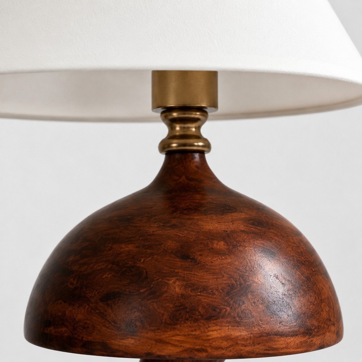 Wood-grain resin body detail under fabric shade