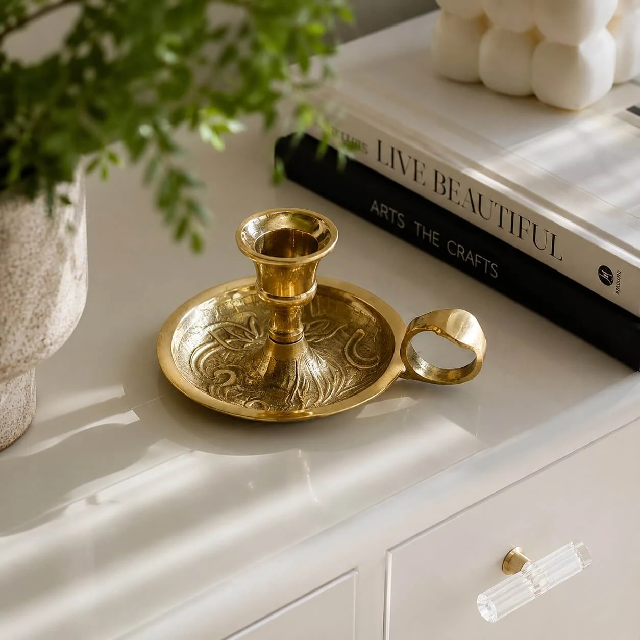 Brass candlestick in a soft window-side home setting
