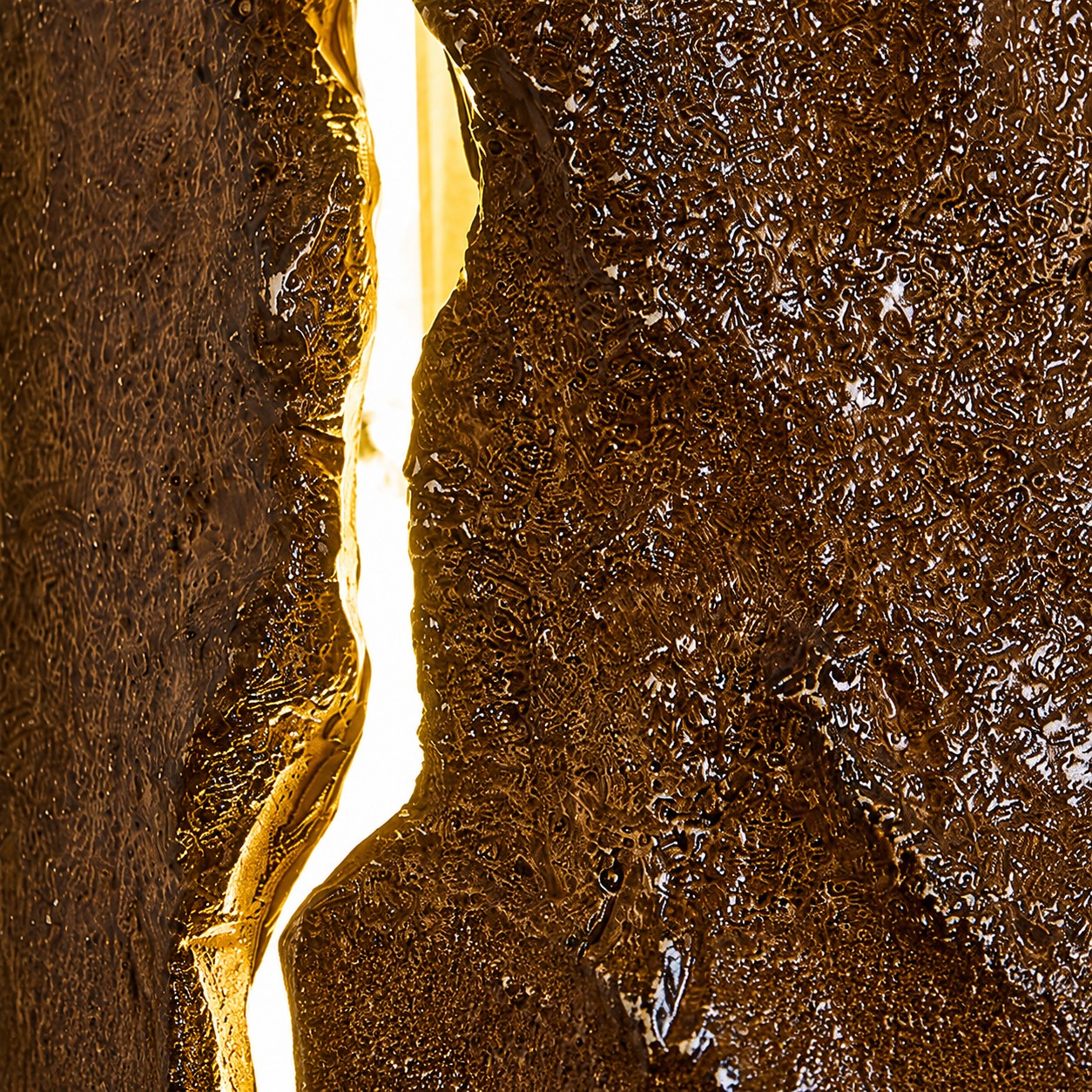 Close-up of glowing split detail on resin wall lamp