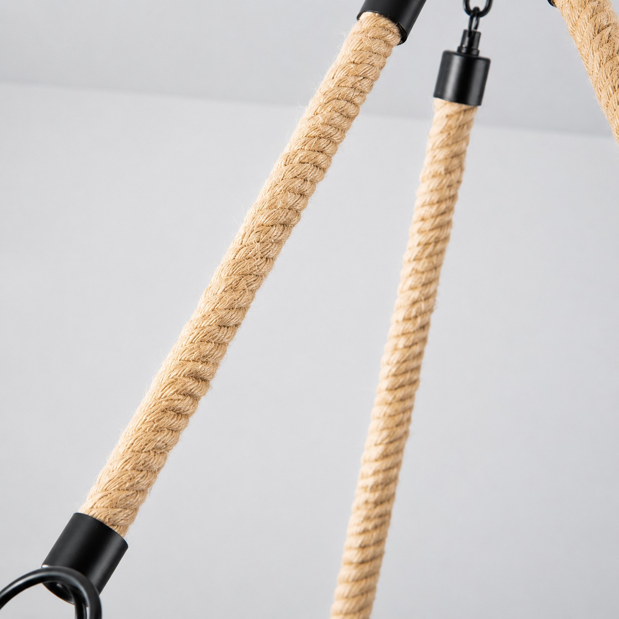 Close view of natural rope wrapped chandelier support arms