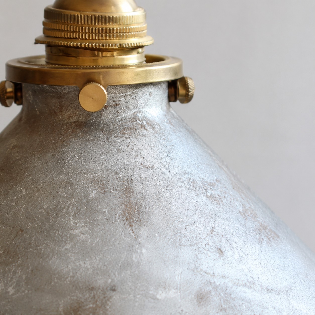 silver hand-rusted shade close-up with brass hardware