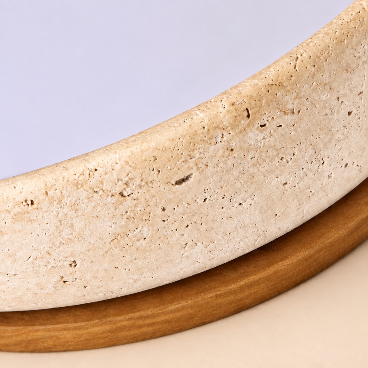 Pitted travertine curve sitting on a walnut wood rim