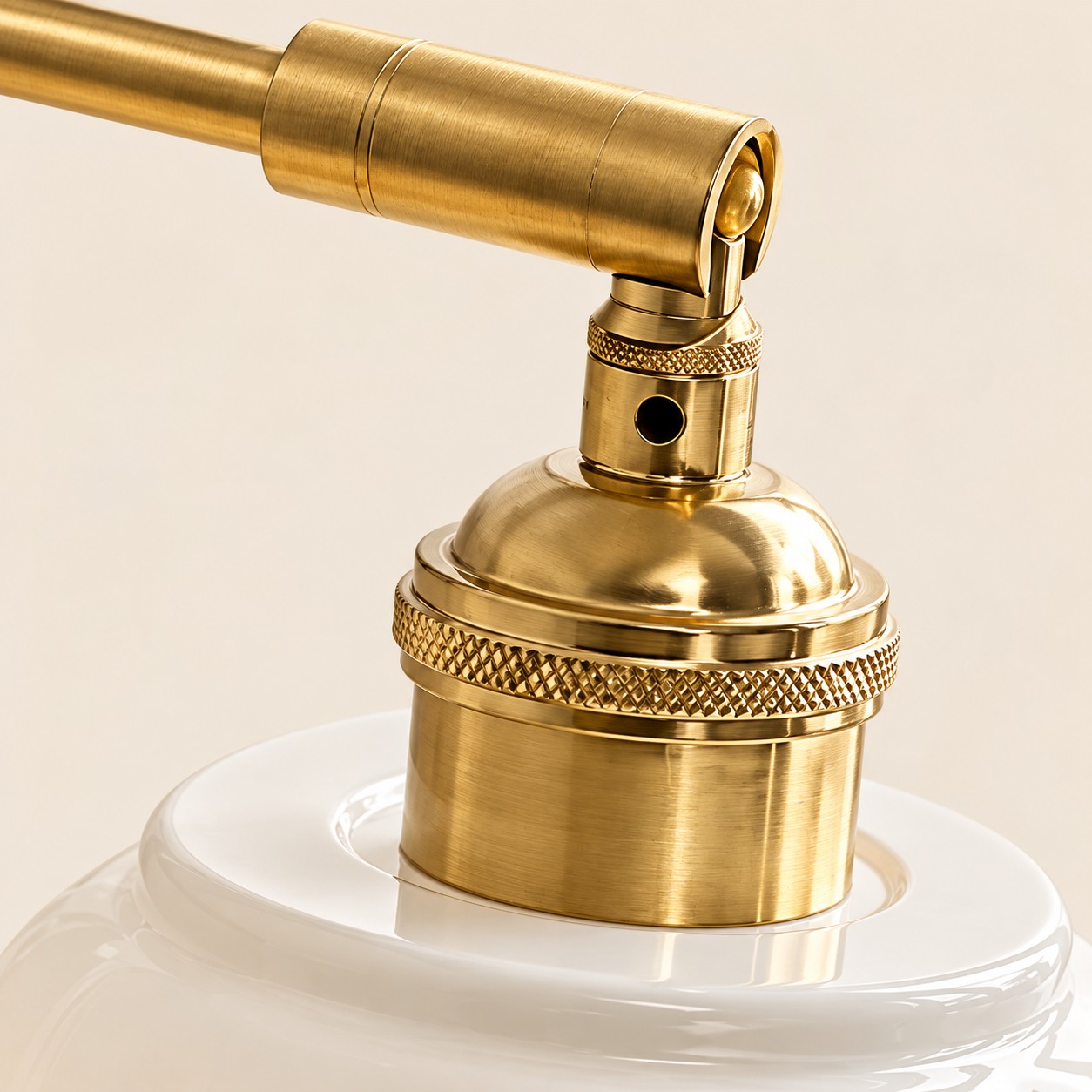 Antique brass socket with a knurled ring above the ceramic shade