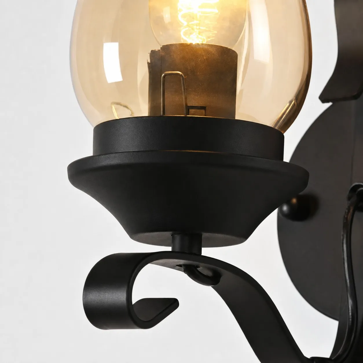 Close view of amber glass shade and E27 socket area
