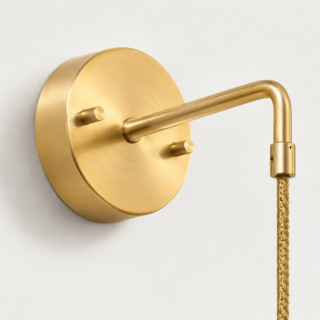 Round brass wall plate and arm connection detail