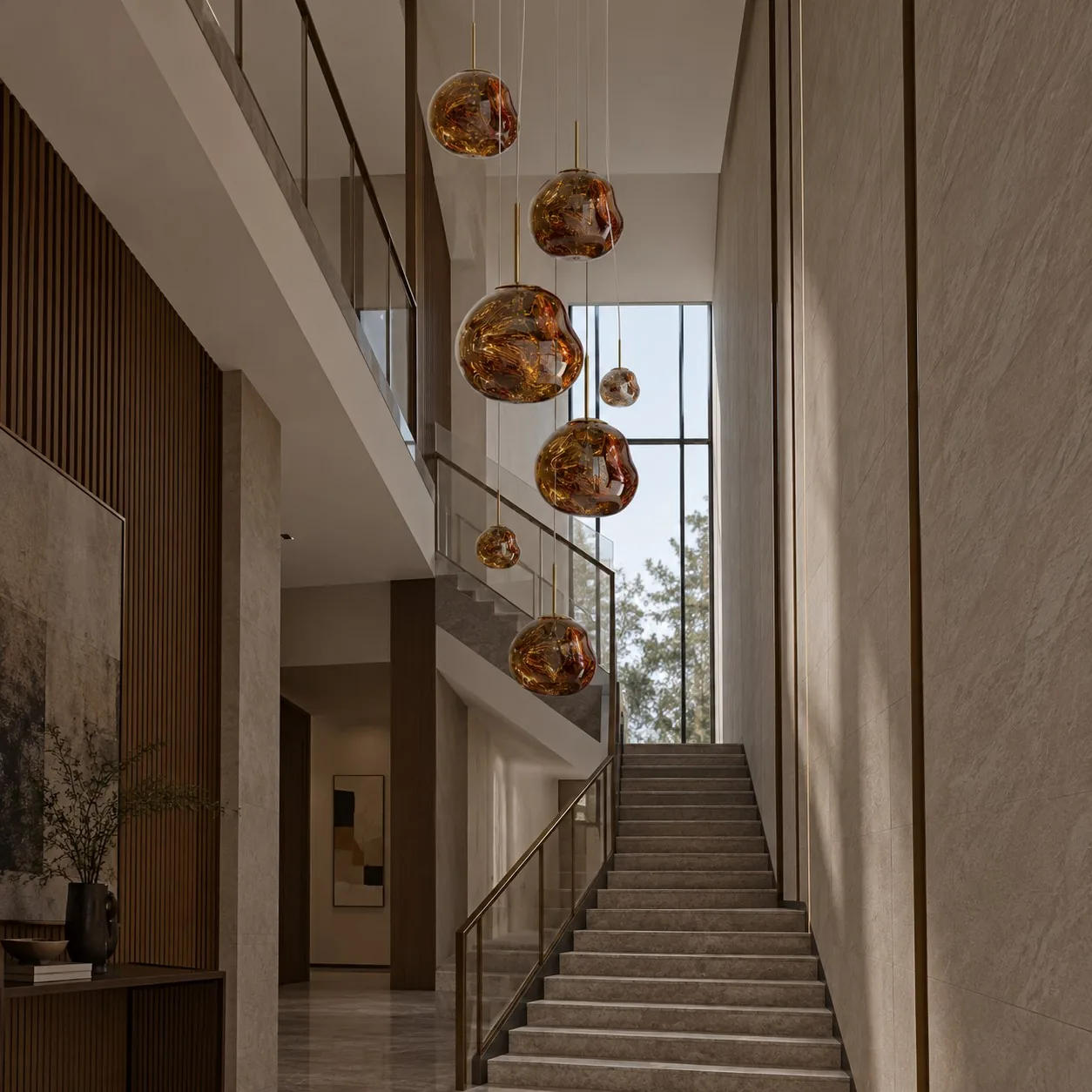 Large gold pendant cluster in a tall foyer